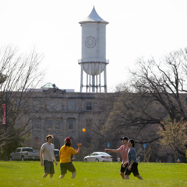 Group of students playing an outdoor game near Marston Tower.