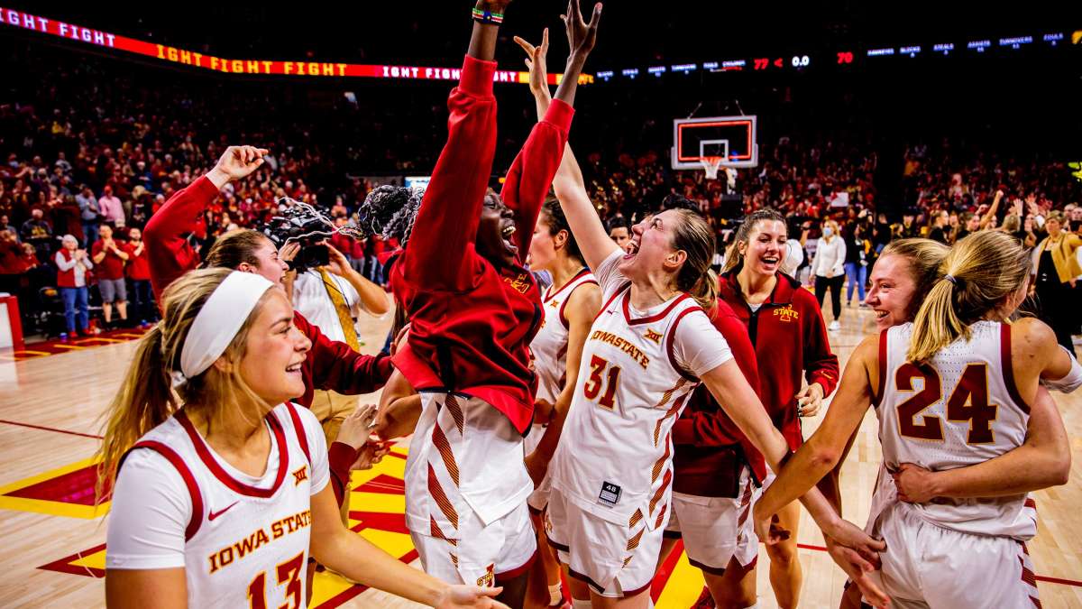 The women's basketball team celebrates after a win.