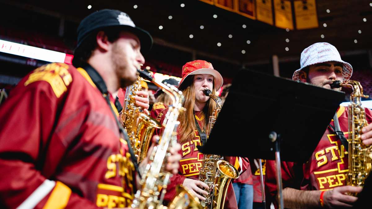 Three saxophone players in the Cyclone Basketball pep band.