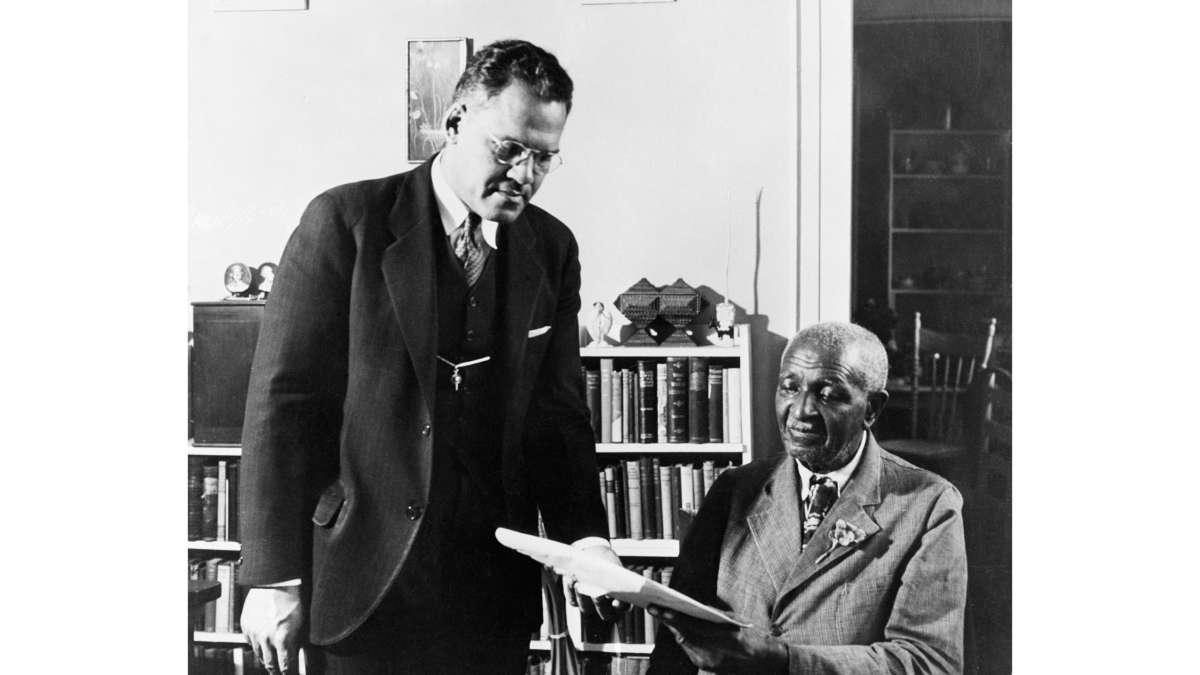 Tuskegee Institute president Dr. Frederick Douglass Patterson and botanist George Washington Carver discuss the postage stamp of Booker T. Washington, 1940.