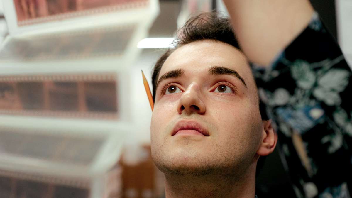 History student Layk Nollen organizes medals from the Charles P. Howard Collection at Drake University as part of his summer research project.